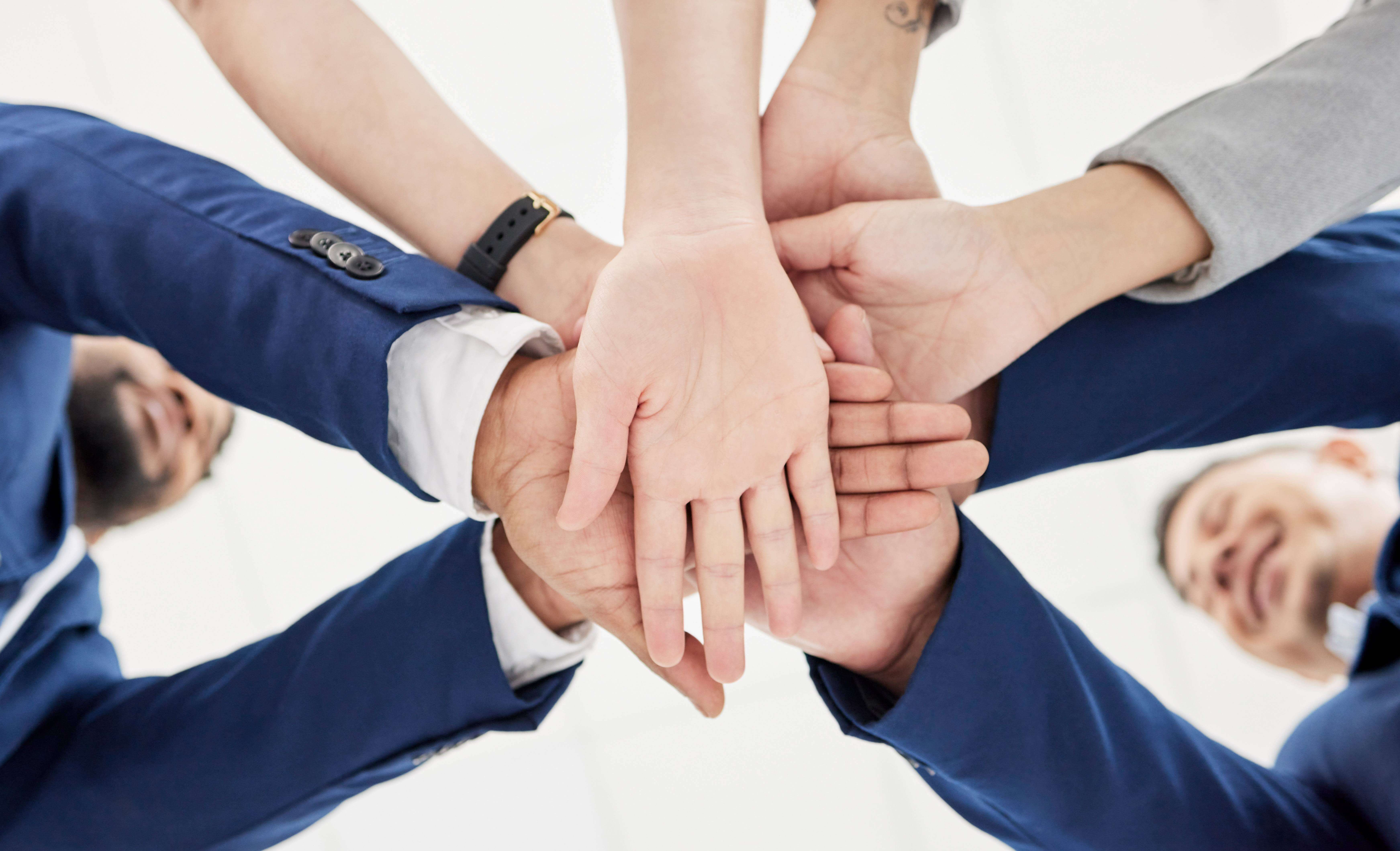 A business team putting hands together